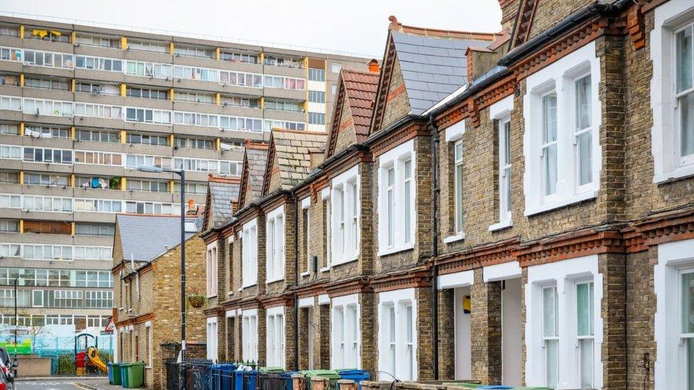 Terraced homes in London with a tower block in the background (file photo)