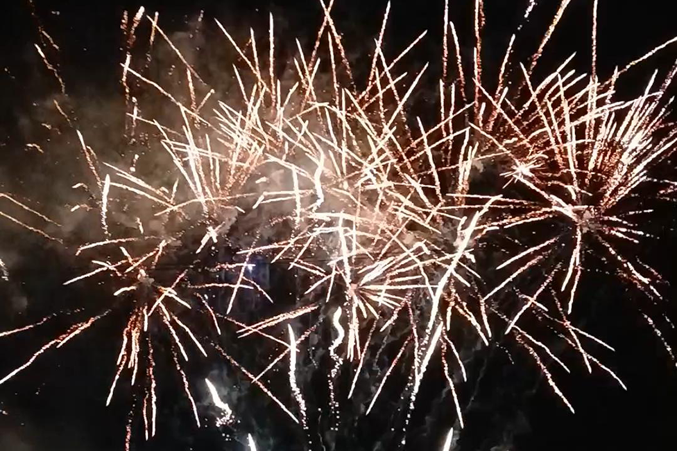 Golden fireworks exploding in a dark sky over Castle Bromwich