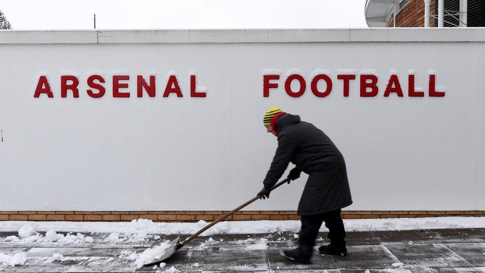 Staff work to clear clear Arsenal's training ground