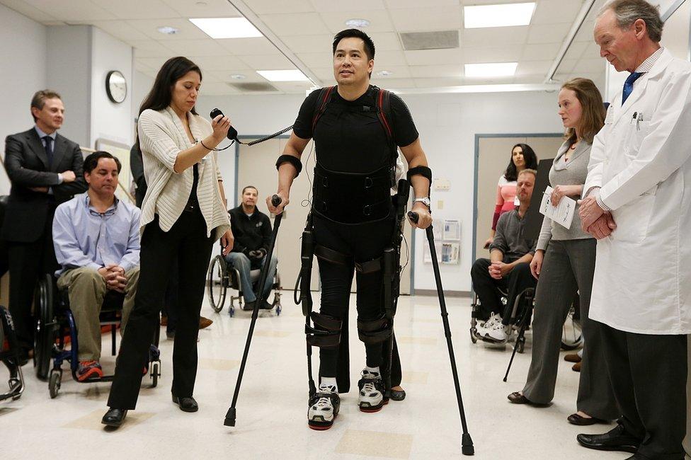 Man with disability walks with the help of an exoskeleton