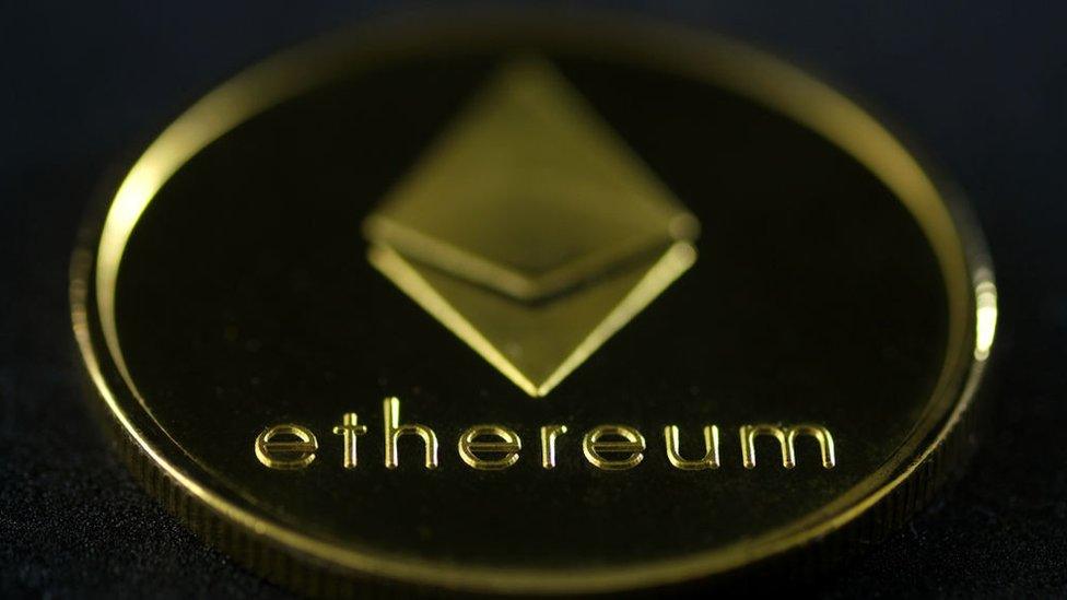 An Etherium "coin" featuring the name and diamond-shaped logo of the currency