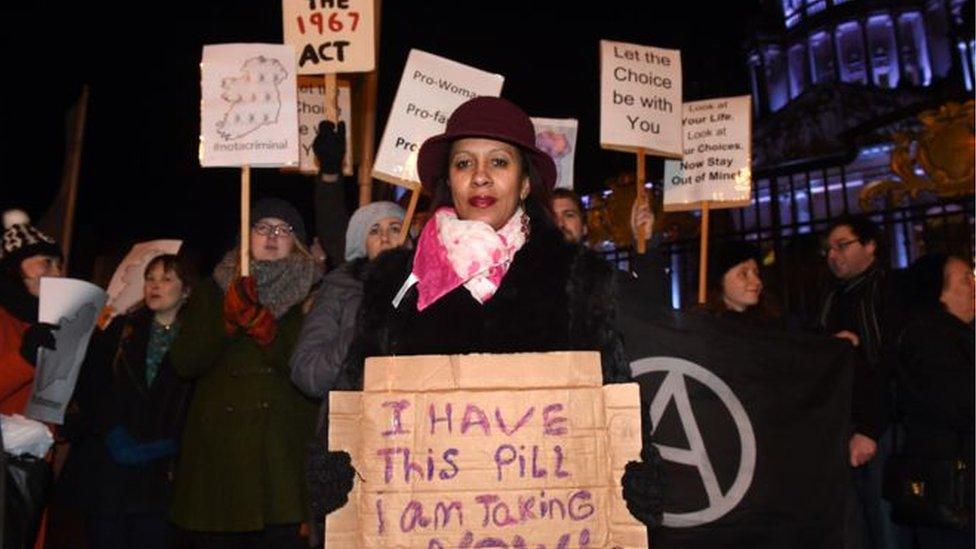 Woman holding sign