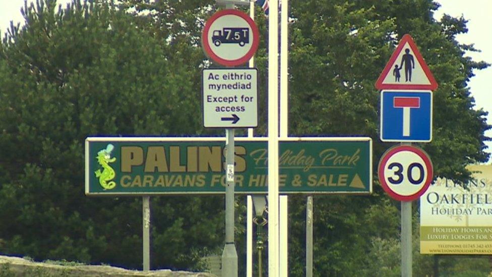 A sign for Palins Holiday Park