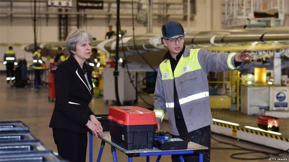 Prime Minister Theresa May speaks to a worker during a visit to the Belfast Bombardier factory in February 2018