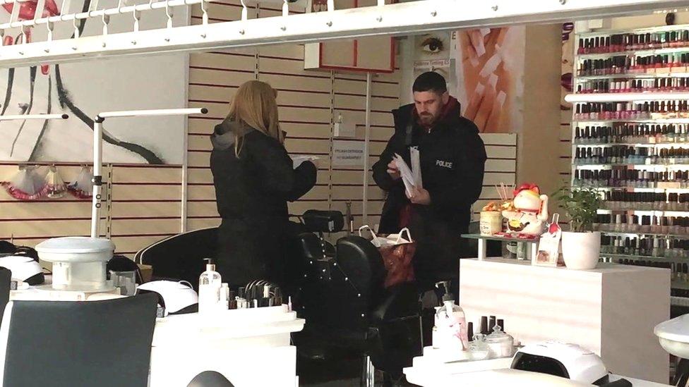 Police in a nail bar