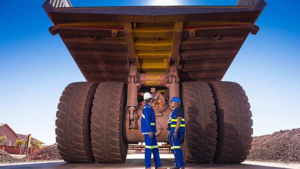 Workers check a truck at Anglo American's Kolomela mine in South Africa