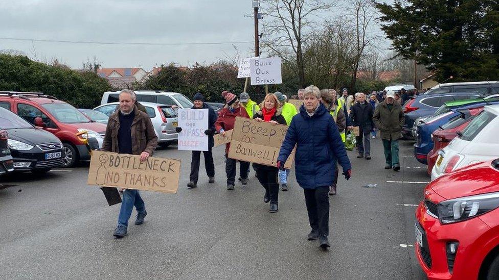 Steve Voller and the protestors head to the road to protest