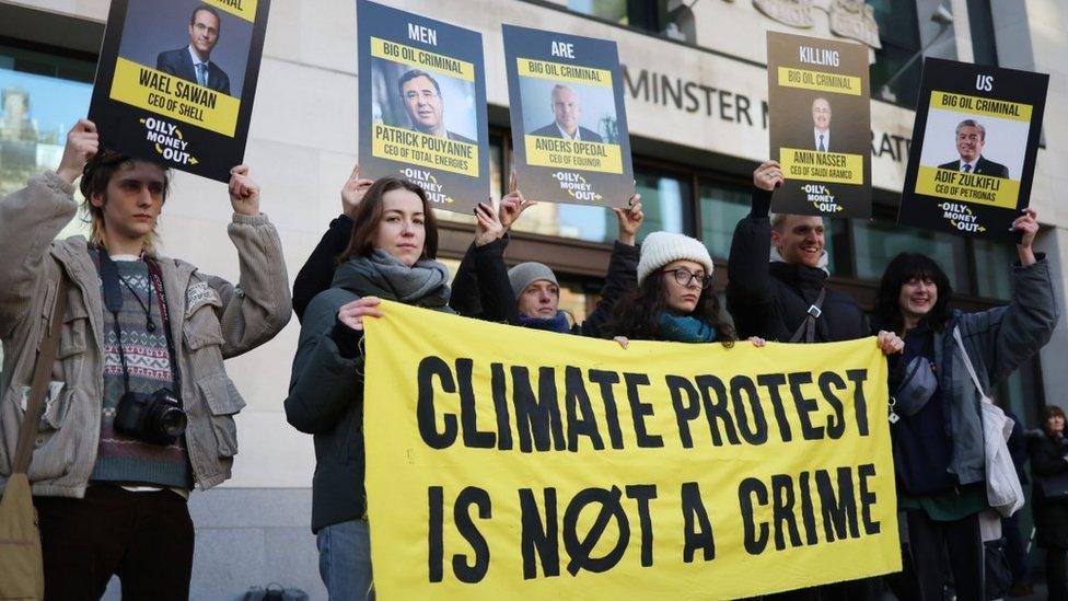 Protesters stood outside court with placards