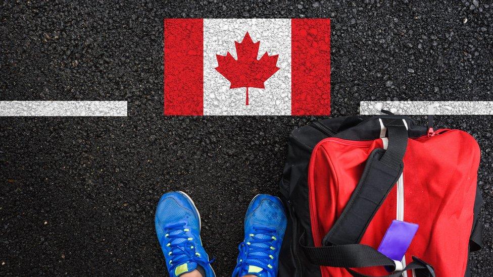 Canadian flag with trainers and bag in shot