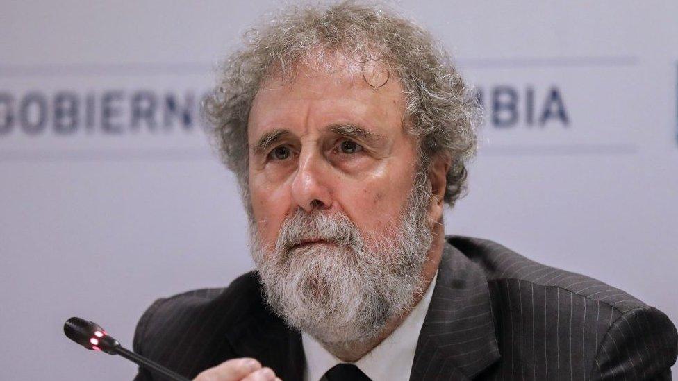 Sir Bob Watson sits in front of a mic at climate conference