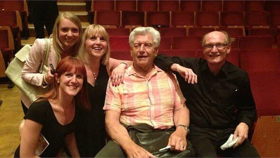 Members of the audience posing with Dave Prowse