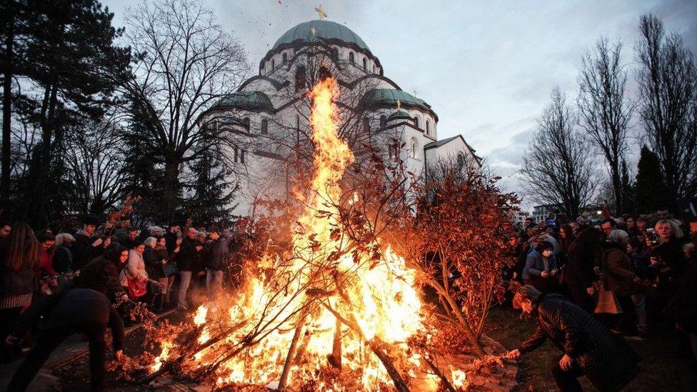 People stand outside the Church of Saint Sava in Belgrade.