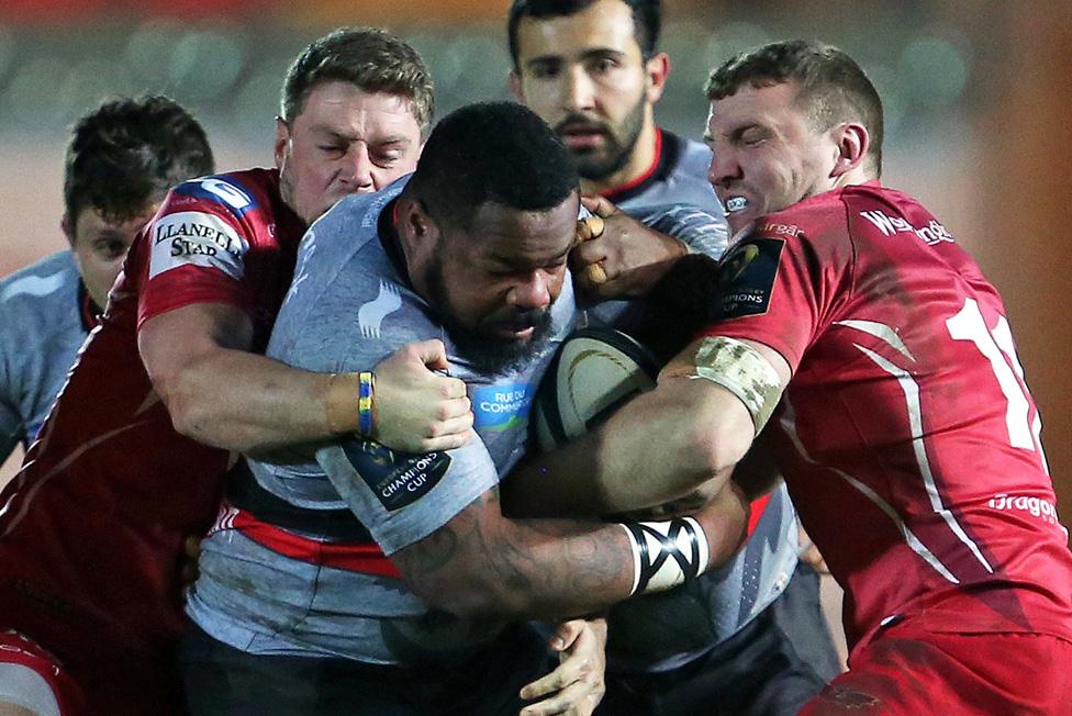 Toulon's French centre Mathieu Bastareaud is tackled during the European Rugby Champions Cup rugby union match between Llanelli Scarlets and Toulon