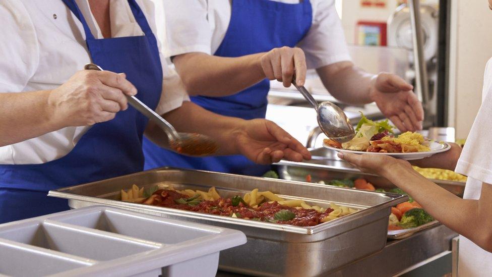 Pupil being served food in a school canteen (stock image)