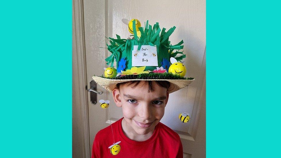 Boy in bee themed hat.