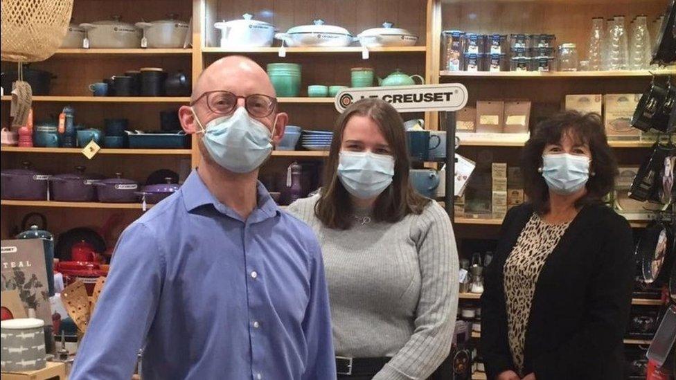 Martin and his staff in store wearing masks