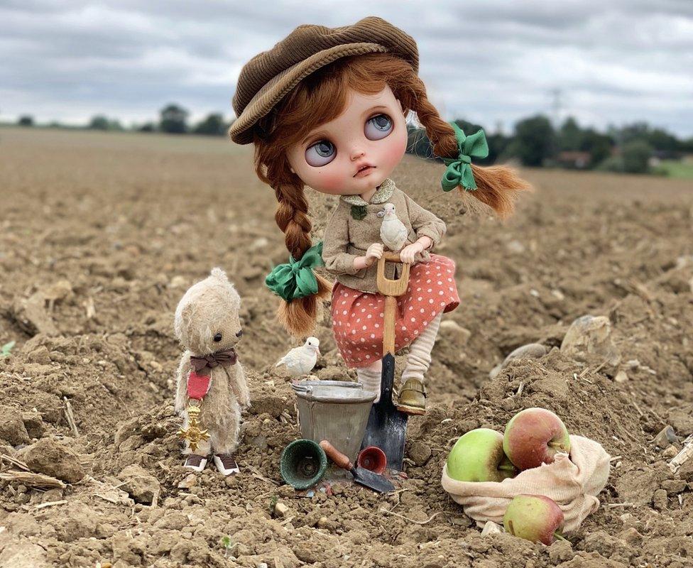 One of the dolls and Ted on a farm