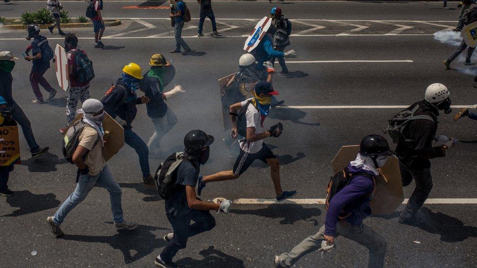 Caracas protesters run down the streets