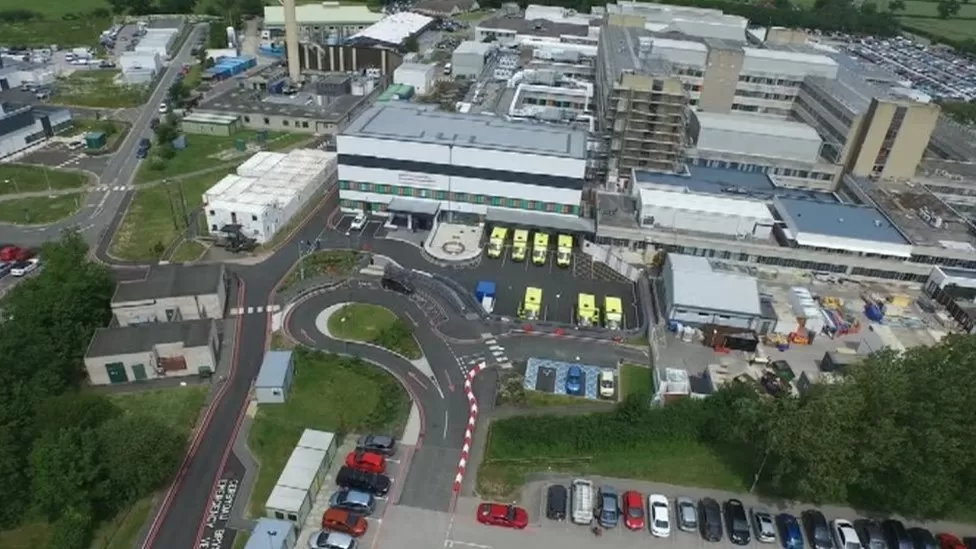 Aerial view of Glan Clwyd hospital facing the emergency department with ambulances parked outside
