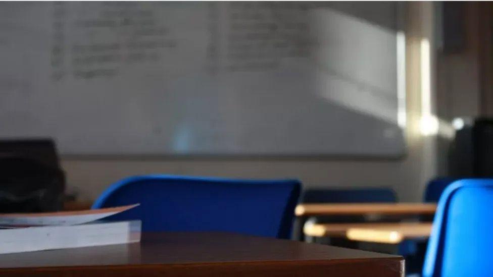 Desk and chairs in a classroom 