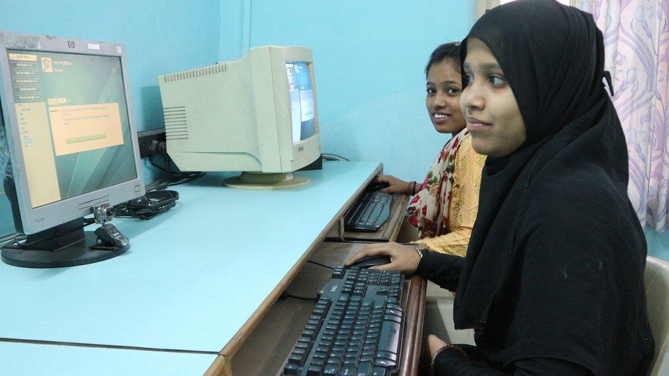 Girls learning how to use computers