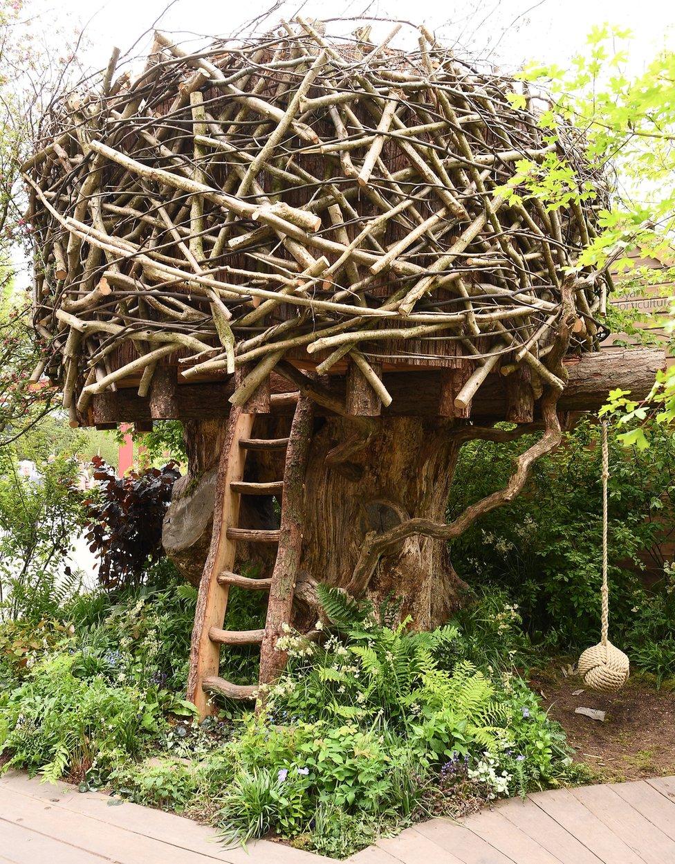 A treehouse in the Back to Nature Garden at Chelsea Flower Show