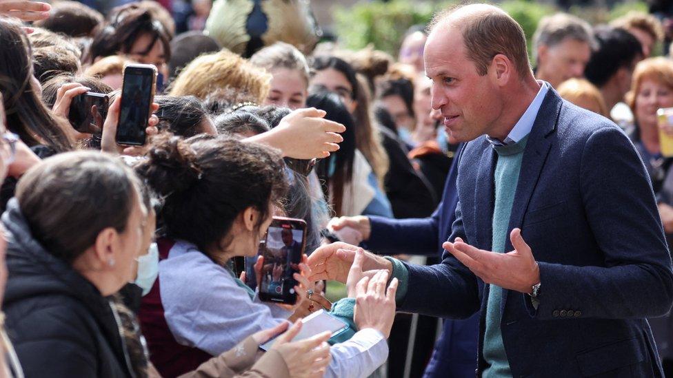 William speaks to people outside the University of Glasgow