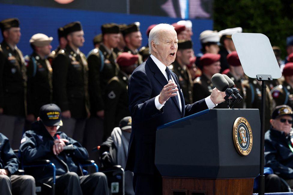 US President Joe Biden delivers a speech, as US WWII veterans look on during the US ceremony marking the 80th anniversary of the World War II "D-Day" Allied landings in Normandy, at the Normandy American Cemetery and Memorial in Colleville-sur-Mer, which overlooks Omaha Beach in northwestern France, on June 6, 2024. 