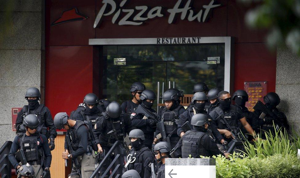 Police gather outside a restaurant near the scene of an attack in central Jakarta January 14, 2016