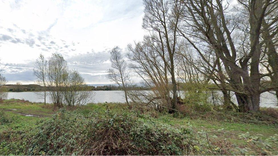 Lake with trees in the foreground