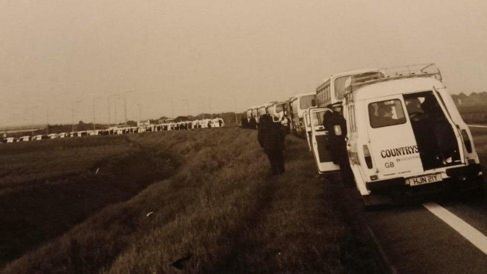 Vans parked on the side of a road