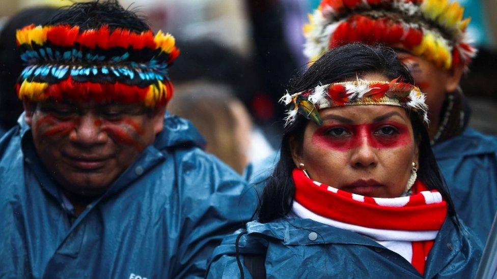 Demonstrators attend a protest as the UN Climate Change Conference