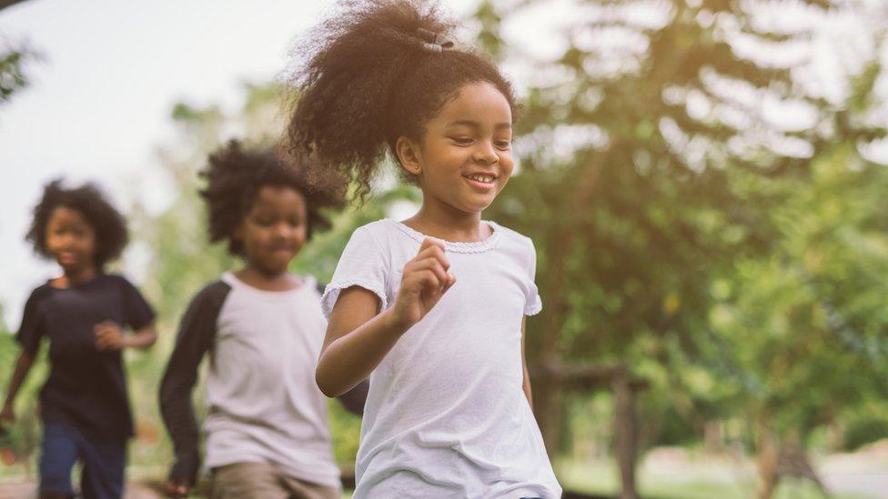 young girl running in forest