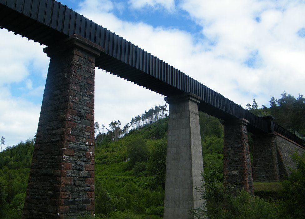 Part of Loch Katrine aqueduct bridge, near Kinlochard, with a wooded hill in the background