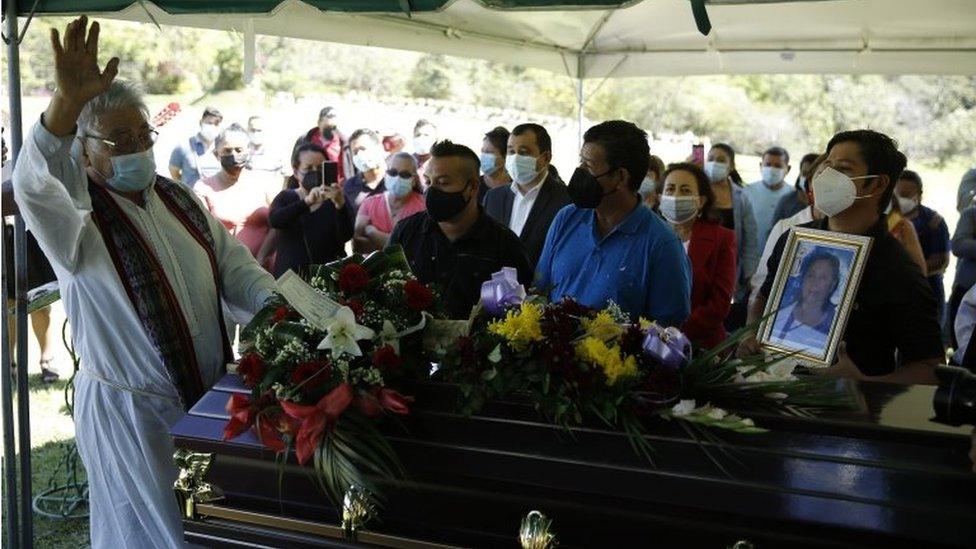 The priest Tilo Sanchez says a prayer during the funeral of Gloria Maria Rogel, a supporter of the FMLN party who died after an armed attack on 31 January, in Soyapango, El Salvador, 02 February 2021.