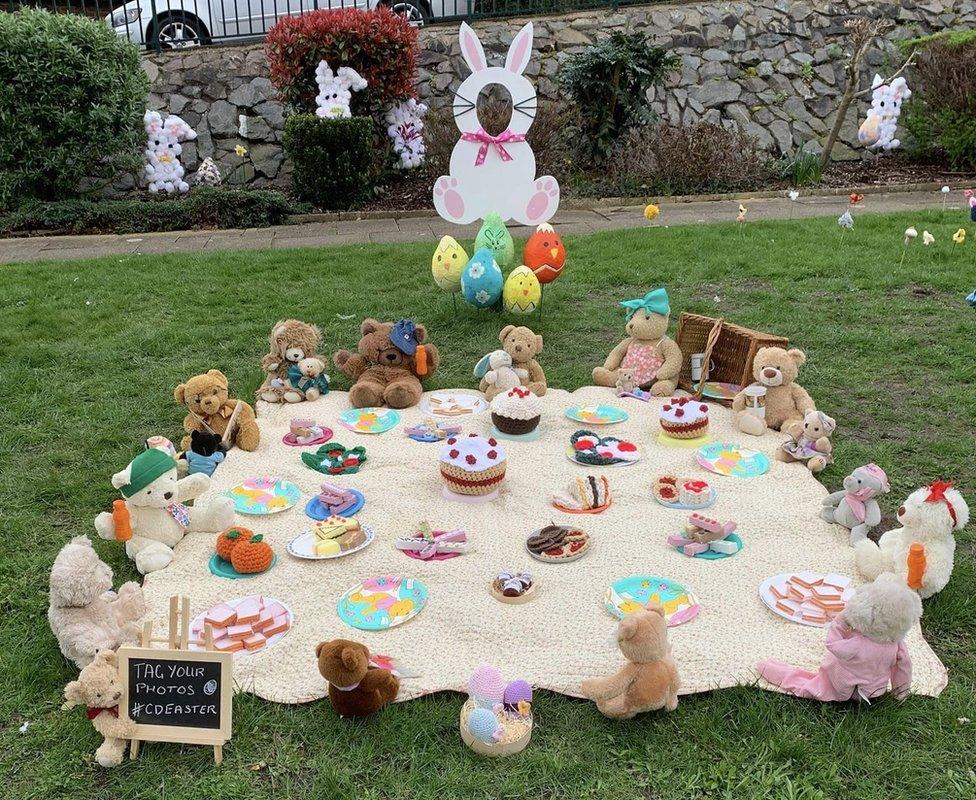 Display features several teddies having a picnic