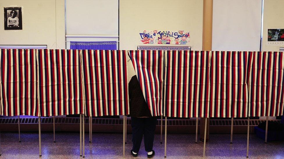 A lone voter casts her vote at a polling station inside a school, during the Super Tuesday Republican primary elections in Cambridge, Massaschusetts,