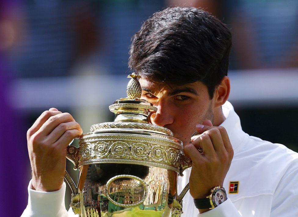 Spain's Carlos Alcaraz holds the Wimbledon trophy after winning his men's singles final against Novak Djokovic