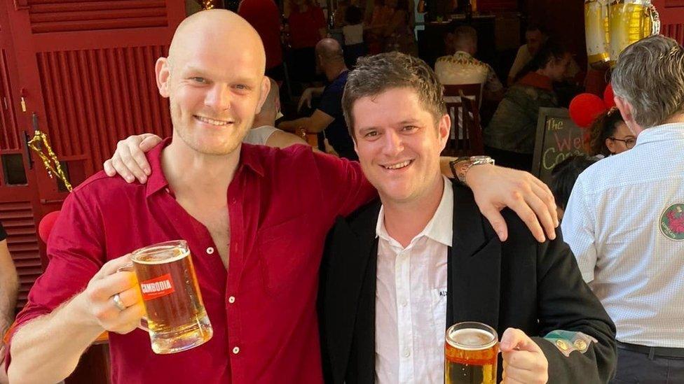 Luke Jones and Ross Clarke holding a beer