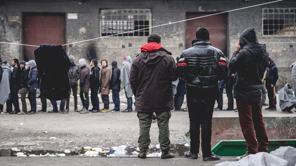 Refugees queue in Belgrade