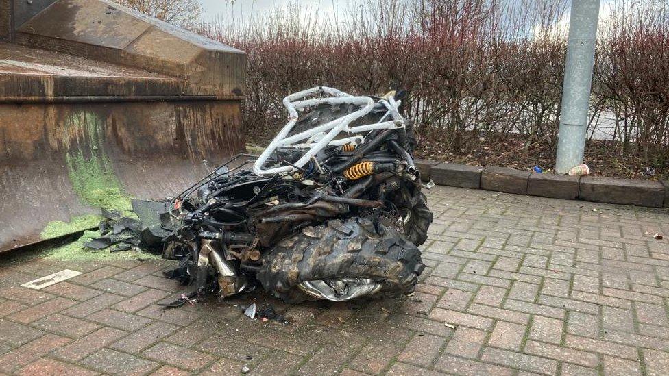 Pile of crushed metal with visible tyre