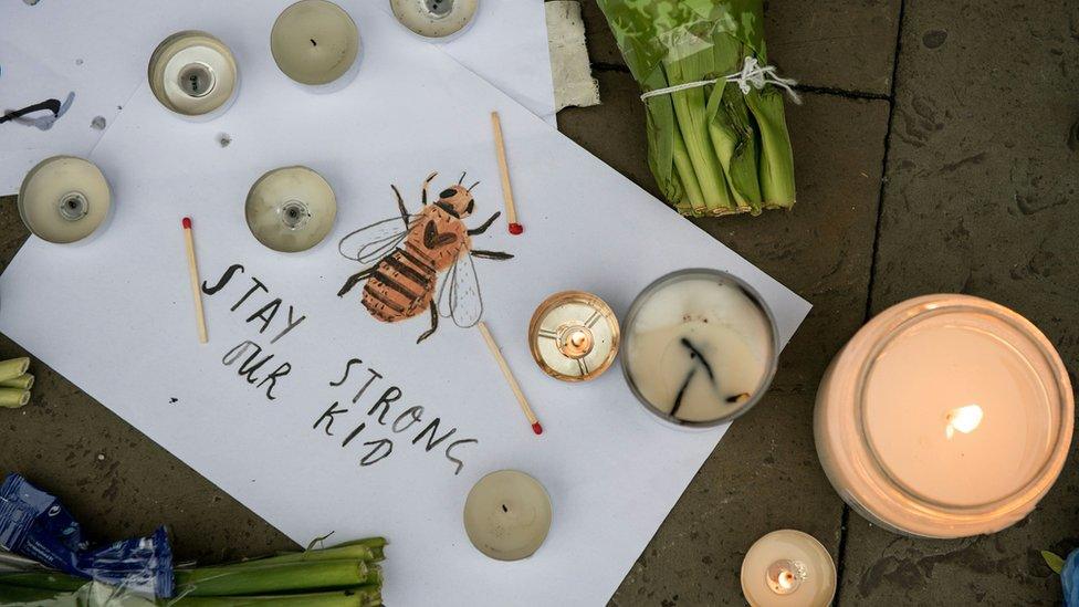 Candles and a hand-drawn message reading "Stay Strong Our Kid" are pictured in Albert Square in Manchester