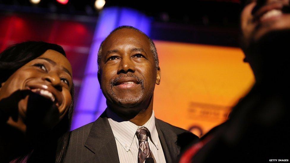 Ben Carson takes photos during the Urban League conference 31 July 2015