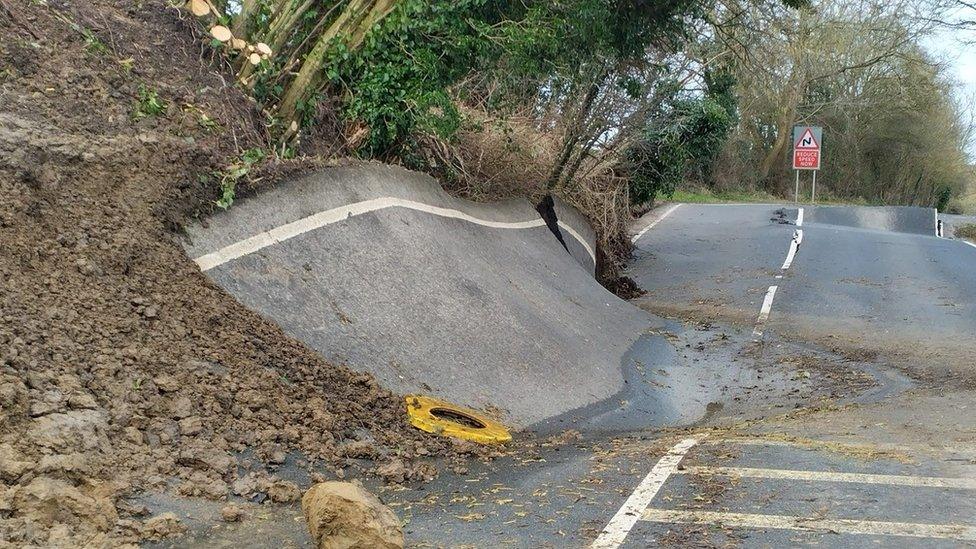 Extremely damaged road, cracked and uneven road