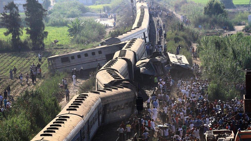 A general view of people by the wreckage after two passenger trains collided in Alexandria