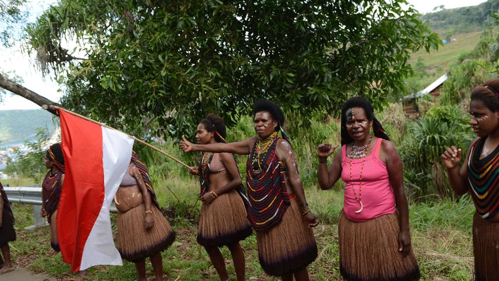 This 2015 picture shows Papuan women greeting the motorcade of Indonesian President Joko Widodo in Jayapura