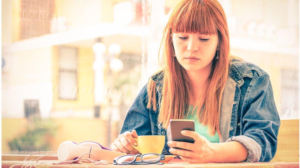 Woman looking at her mobile phone