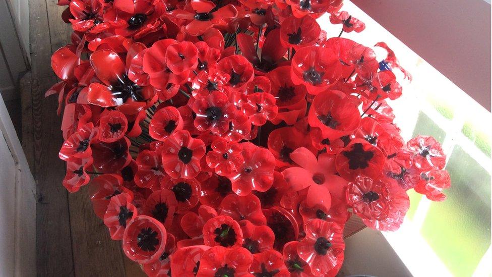 A bunch of painted poppies made from plastic bottles