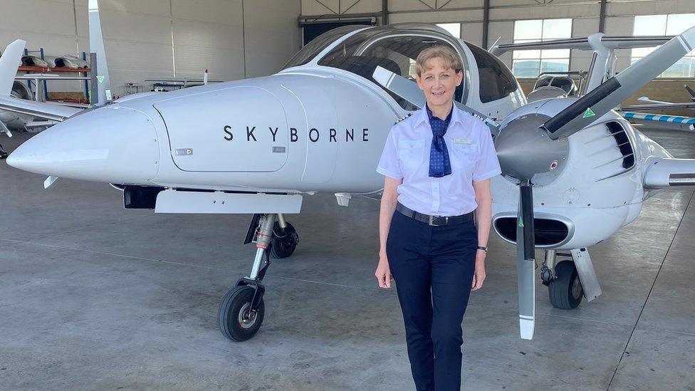 Julie in front of a plane