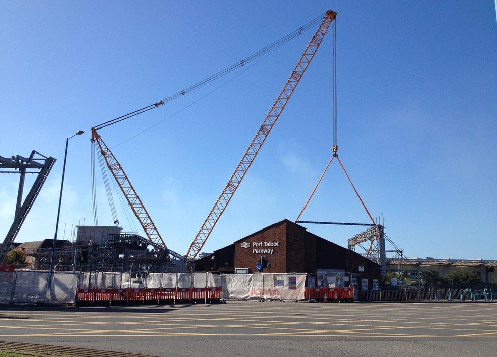 A crane helps to lower the bridge into place